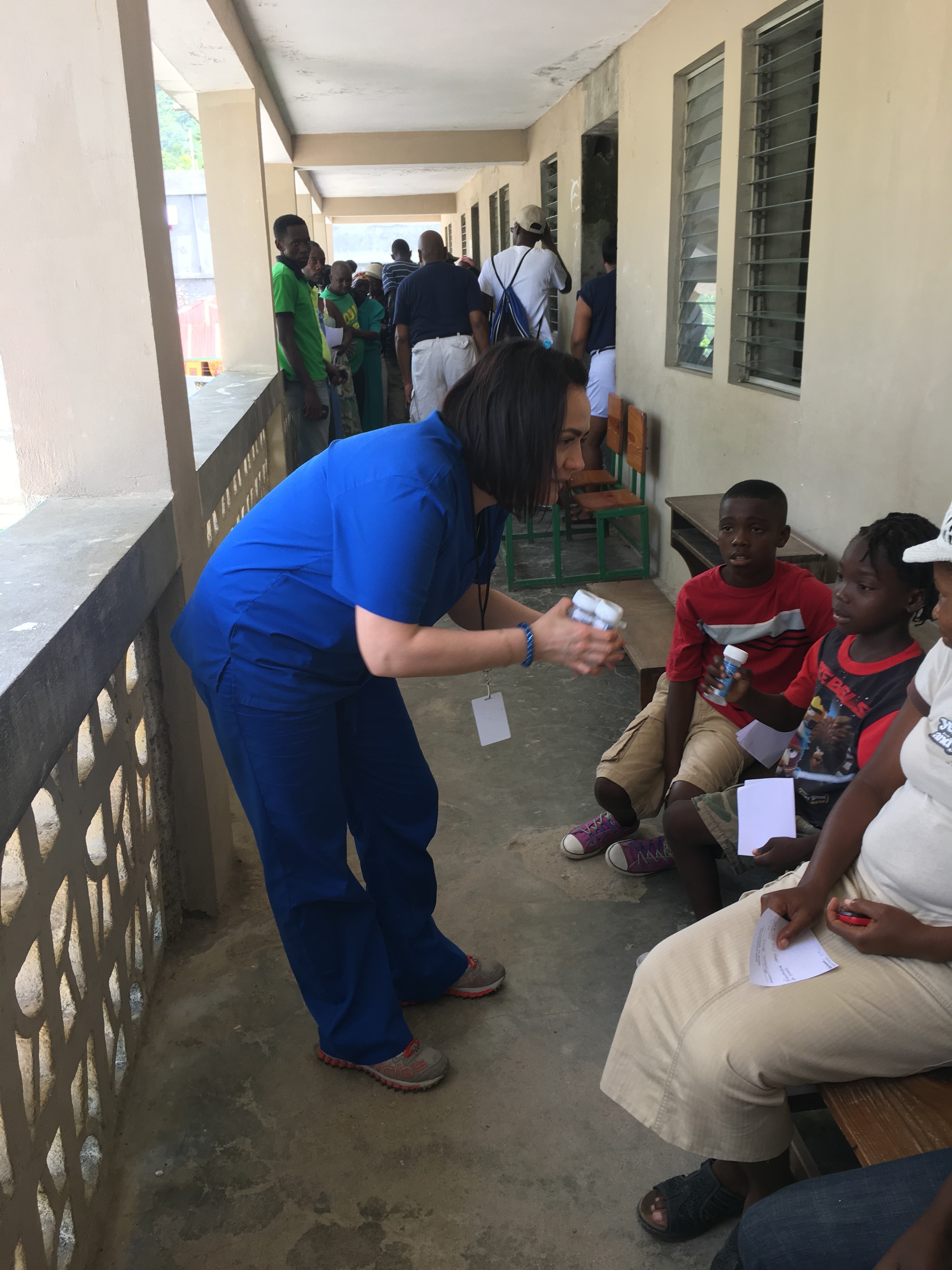 P4 Olga Rashchupkina gives children Pedialyte in Haiti. 