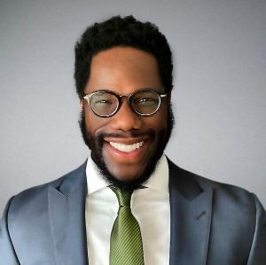 Headshot of Dr. Paul J Isikwe smiling. 