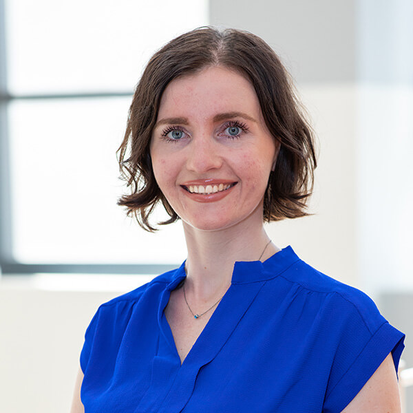 headshot of Dr. Tamara Hernandez in a bright blue top in front of a window (white background)