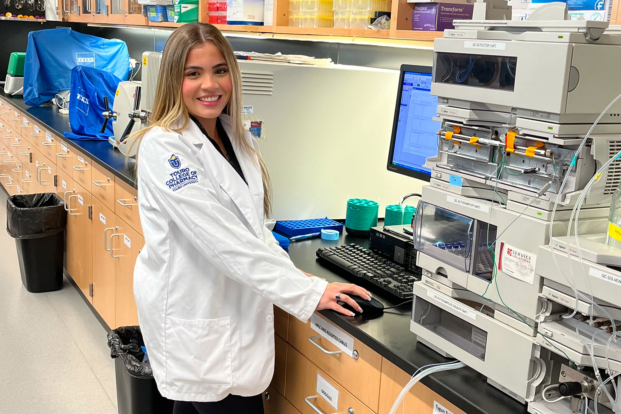 Female student smiling while working in lab