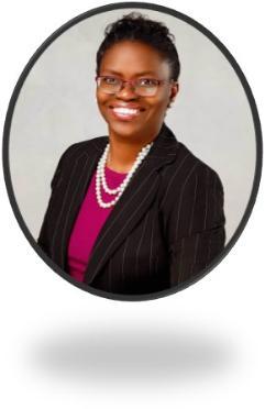 Headshot of Toyin Tofade with a warm and friendly smile set against a blank background. 