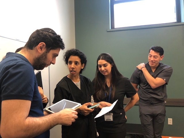 Touro College\'s pharmacy, osteopathic medicine, and dental students working together on a patient\'s case escape room style.