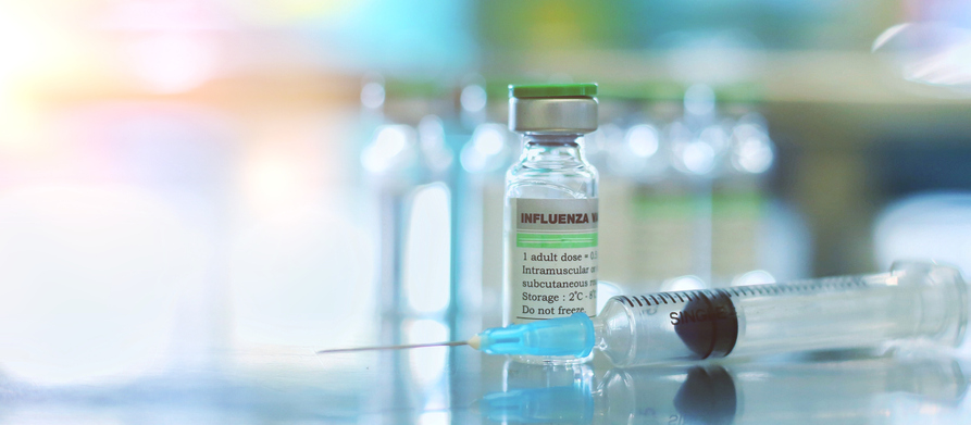 Flu vaccine bottle and shot