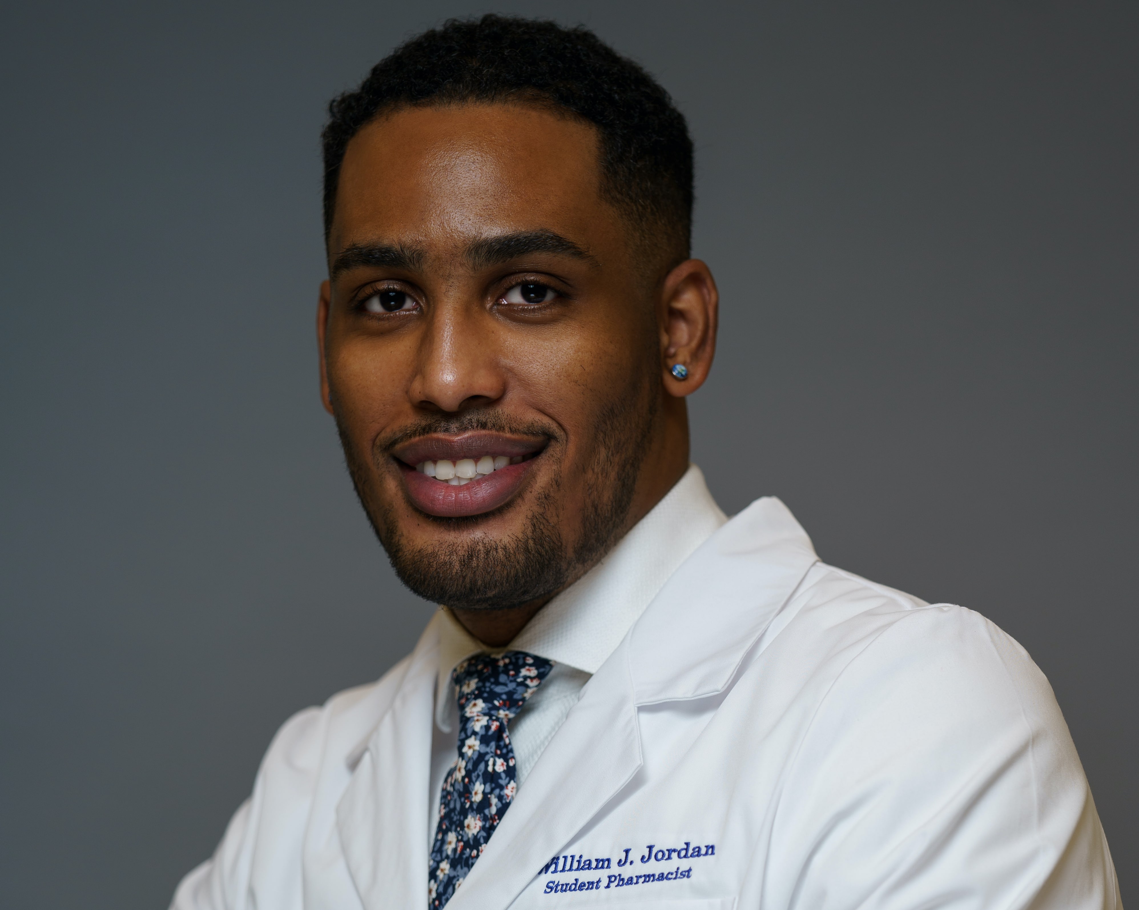 TCOP class of 2024 pharmacy student William Jordan in his white coat.