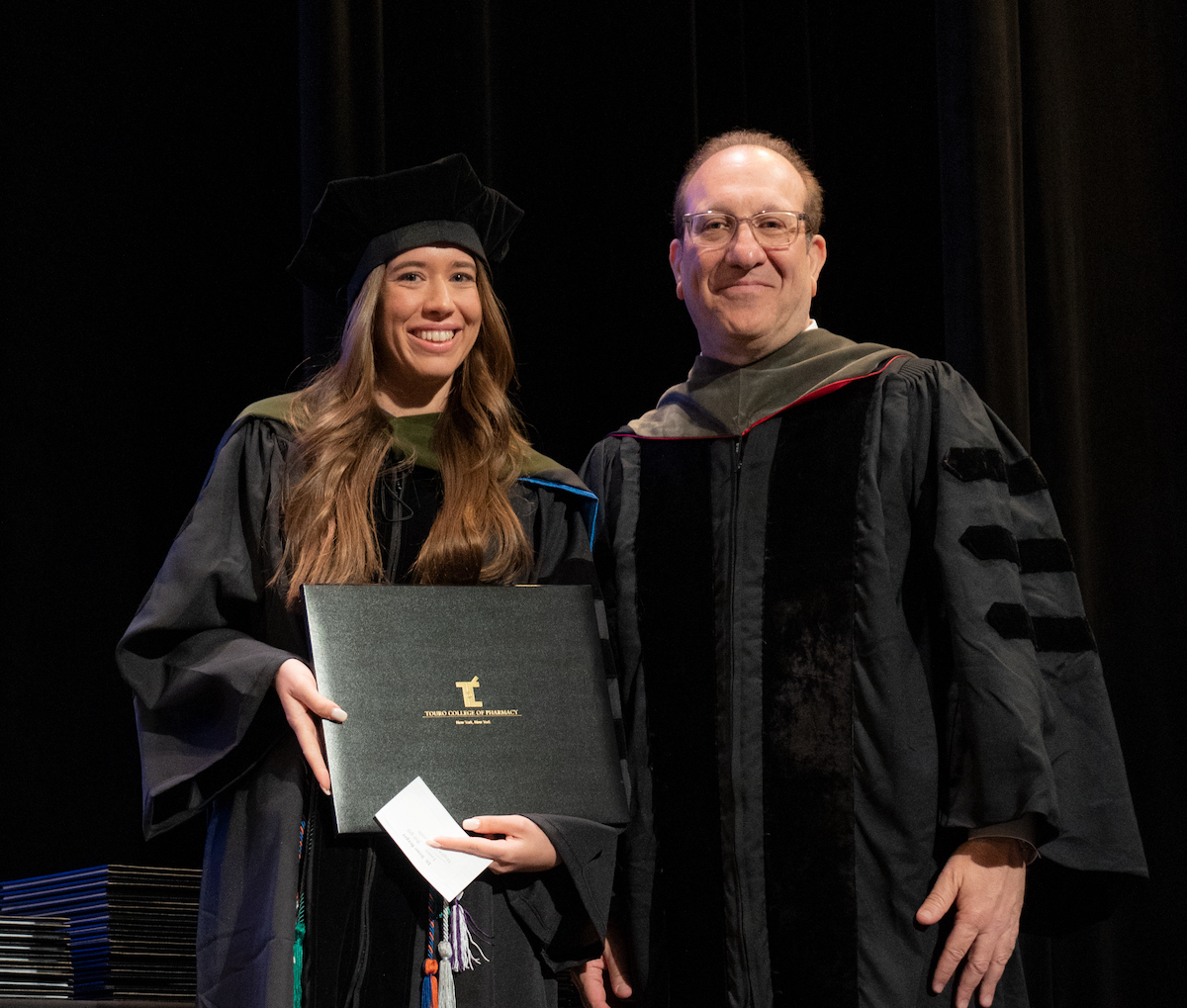 Irene Berger receiving her diploma from TCOP Dean Henry Cohen
