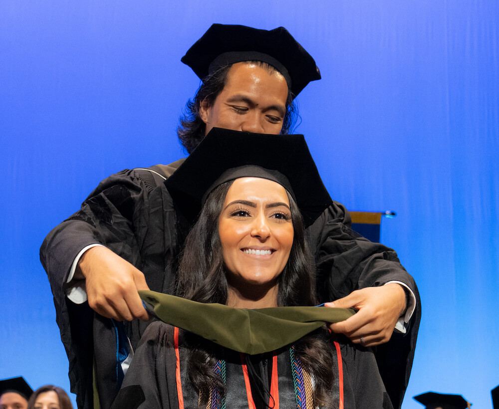 Madrona Boutros is hooded during Touro College of Pharmacy\'s 2023 commencement exercises.