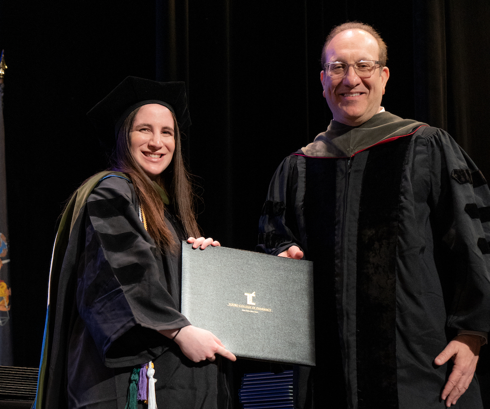 Tzivia Gutman receiving her diploma from Touro College of Pharmacy Dean Henry Cohen