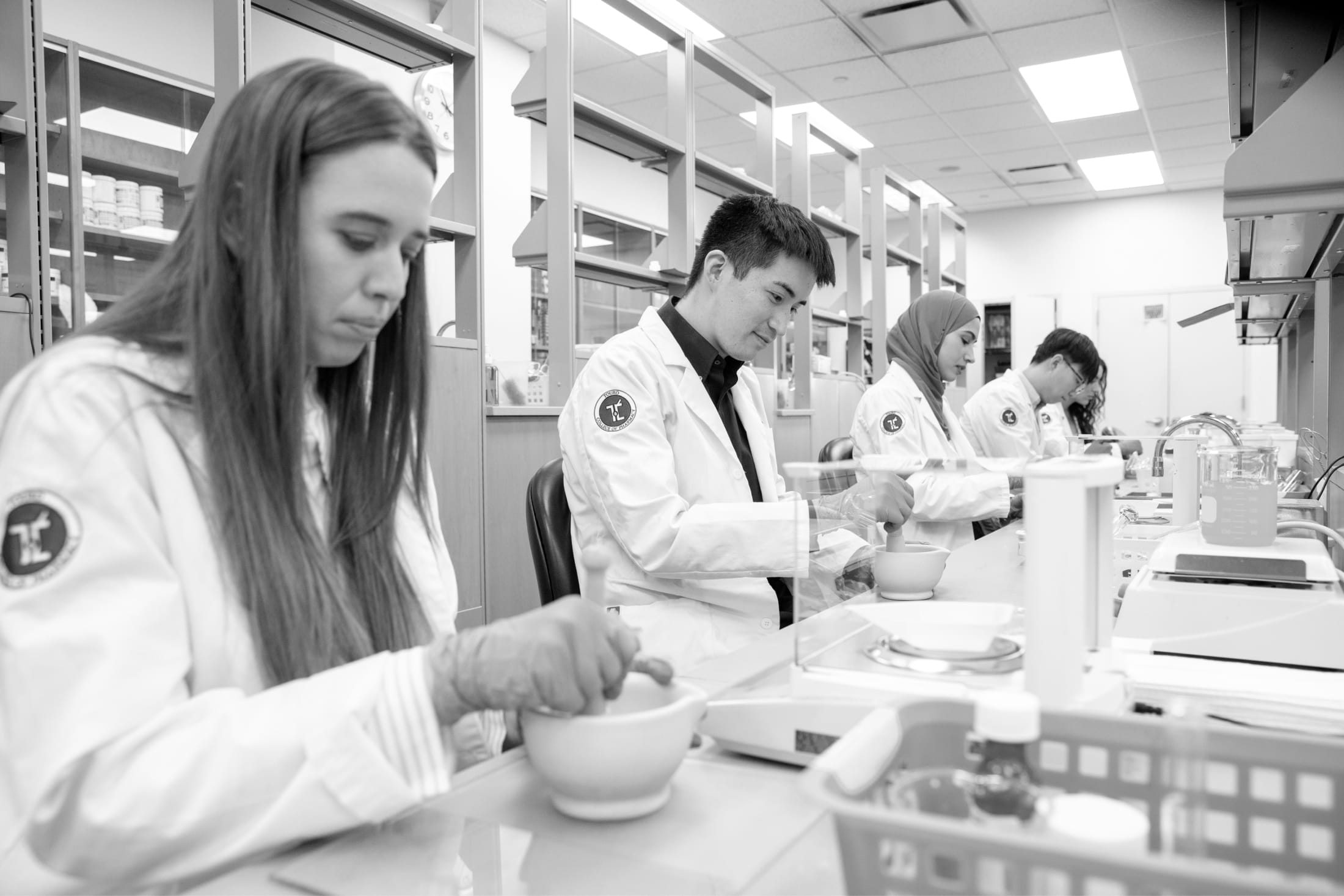 students in lab compounding medicines