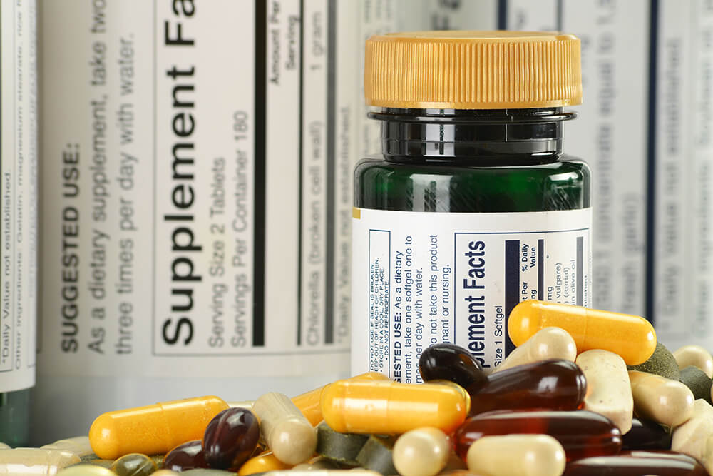supplement bottle and loose supplement pills