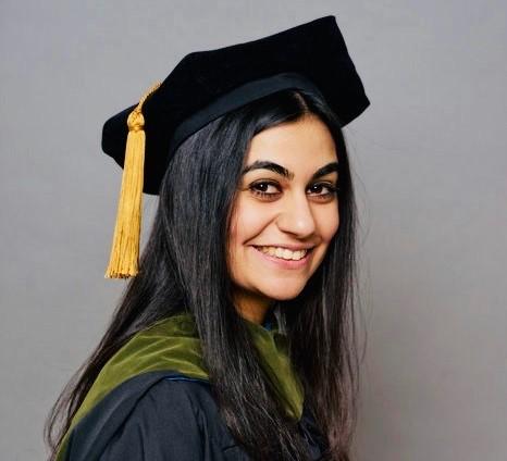 Graduation photo of Nabila Girgis, PharmD, MHA, in her cap and gown. 