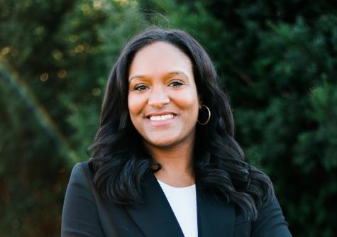 Pharmacy school alumna Shalon Jones, PharmD, MPH, outside with trees in the background.