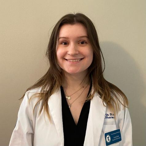 Victoria Stone in her white coat smiling at the camera. 