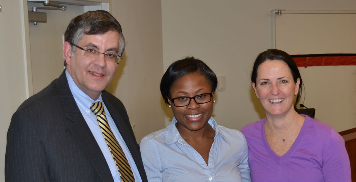 Dr. Zvi Loewy, interim dean of the pharmacy school (left) and Dr. Maureen Sullivan, chair of the Dept. of Pharmacy Practice, (right) congratulate CVS Caremark Charitable Trust Pharmacy Scholarship recipient Tiffany Murray. 